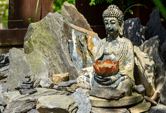statue of buddha in the temple japan garden with balnce stones