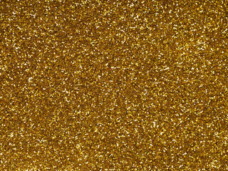 Gold or ogange glitter texture sparkling shiny wrapping paper background for Christmas, xmas,...
