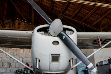 Small white airplane with black aircraft propeller