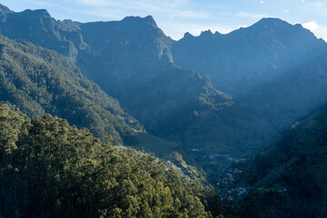 A breathtaking aerial view of the Madeira mountain range, showcasing its lush valleys and trees with tranquil plateaus. Nature at her finest!