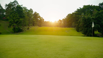 Beautiful golf course in a sunny day. Background evening golf course has sunlight shining down.