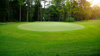 Beautiful golf course in a sunny day. Background evening golf course has sunlight shining down.