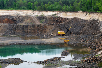 Extraction of resources in a quarry. Granite quarry in the summer. Stone quarry