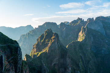 Mountain trail Pico do Arieiro, Madeira Island, Portugal Scenic view of steep and beautiful mountains and clouds during sunrise. October 2021