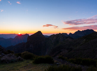 Sunrise in Madeira mountains peaks in sunlight, scenic view over landscape and Pico Ruivo, Portugal.