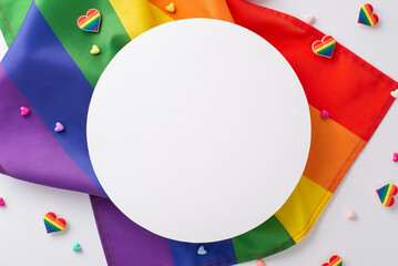A top view of LGBT-themed parade gear, featuring rainbow flag, heart ornaments, pin badges arranged on a white backdrop with a circular opening for text or branding - obrazy, fototapety, plakaty