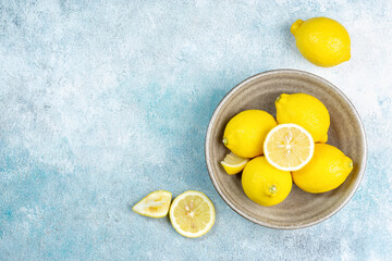 Fresh lemons on bright background. Lemon fruit citrus. Composition with whole, slices of lemons.