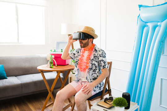 Mid-adult man having fun with virtual reality during staycations
