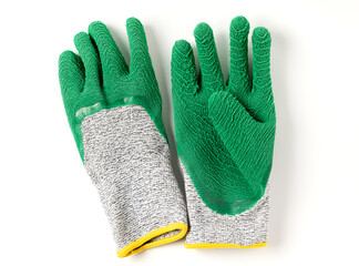 Top view of green very high cut resistance gloves covered with crinkled latex on white background.