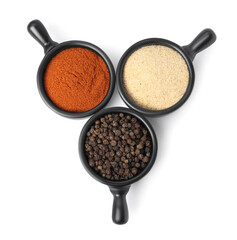 Bowls with different spices on white background, top view