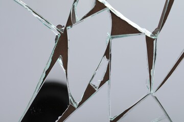 Shards of broken mirror on backing board, top view