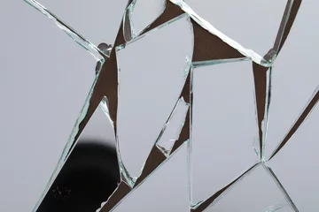 Gordijnen Shards of broken mirror on backing board, top view © New Africa
