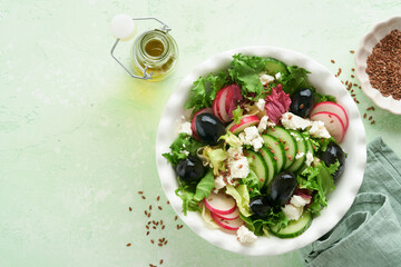 Lettuce salad, cucumber, radish salad with cottage cheese and flax seeds olive oil salad. Healthy diet food. Diet menu and balanced diet. Top view.