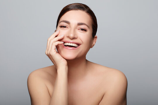 Skincare Concept. Smiling natural woman with nude makeup on a flawless skin