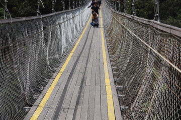 Fototapeta premium suspension bridge structure of wood and steel cables