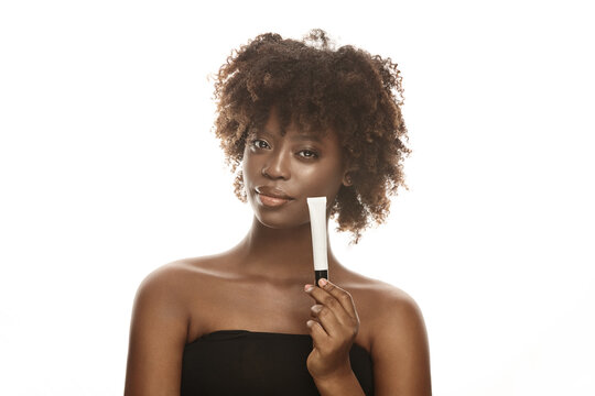 African female model demonstrating cosmetic tube mockup.
