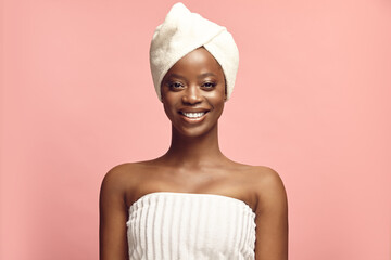 Afro-american woman dressed in body and hair towels. - Powered by Adobe