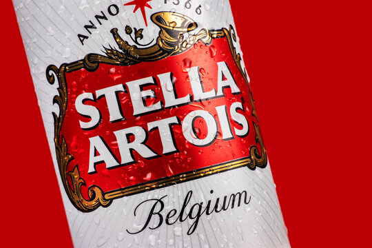 Ukraine. Dnipro. 20 march 2023: Stella Artois beer can with condensation water droplets on red background