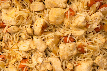 Tasty pilaf with chicken as background.