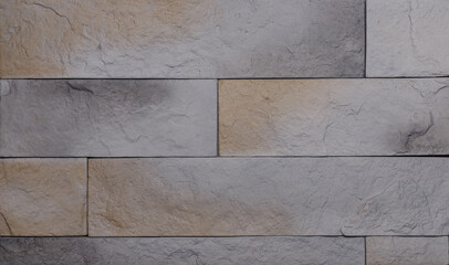 The texture of the wall is made of beige natural stone blocks or brick decorative tiles
