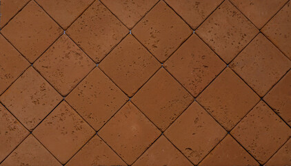 The texture of the wall is made of beige natural stone blocks or brick decorative tiles