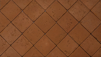 The texture of the wall is made of beige natural stone blocks or brick decorative tiles