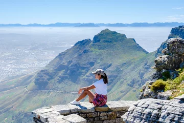 Foto auf Acrylglas Tafelberg view from the Table Mountain in Cape Town South Africa, view over the ocean, and Lion's Head from Table Mountain Cape Town, Asian women hiking in the mountains of Cape Town South Africa