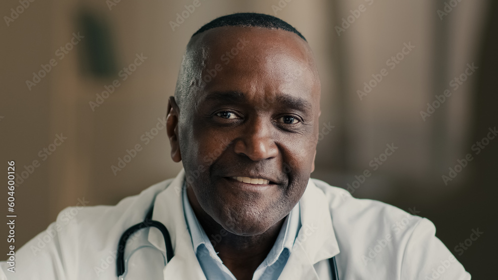 Wall mural Medical portrait of male senior therapist doctor african american man physician oculist gynecologist ophthalmologist senior general practitioner sit at office hospital cabinet health and care concept