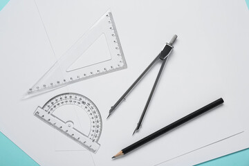 Different rulers, pencil, compass and paper sheets on turquoise background, flat lay © New Africa