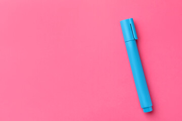 Bright light blue marker on pink background, top view. Space for text