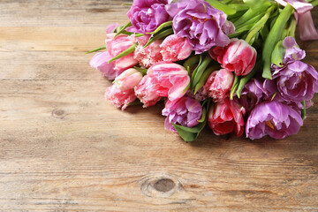Beautiful bouquet of colorful tulip flowers on wooden table