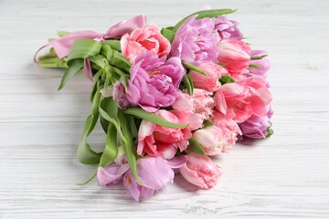 Beautiful bouquet of colorful tulip flowers on white wooden table