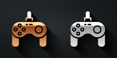 Gold and silver Gamepad icon isolated on black background. Game controller. Long shadow style. Vector