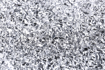 Crumpled silver foil as background, closeup view