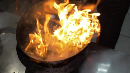 Stir Fry Cooking Of Thai Food In Wok On Open Flame