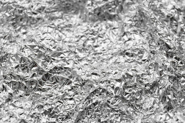Crumpled silver foil as background, closeup view