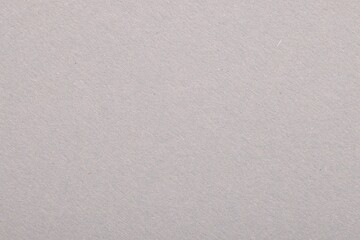 Texture of light grey paper sheet as background, top view