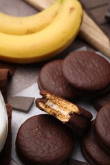 Tasty banana choco pies on table, closeup