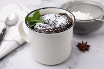 Tasty chocolate mug pie on white marble table, closeup. Microwave cake recipe