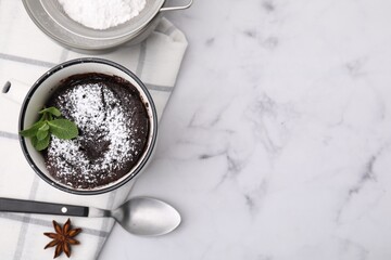 Tasty chocolate mug pie on white marble table, flat lay with space for text. Microwave cake recipe