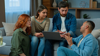Multiracial friends working online with laptop order delivery at home diverse group men and women colleagues using computer web app in living room creative team talk discuss ideas startup brainstorm