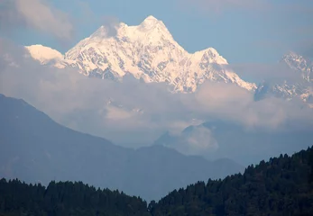 Foto auf Acrylglas Kangchendzönga The magnificent view of fog covered Mt. Kangchenjunga, the third highest mountain in the world measuring situate at 8,586 m (28,169 ft) as seen from Gangtok, Sikkim.