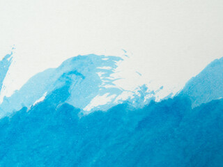 Blue paint and splash and white background, copy space above.