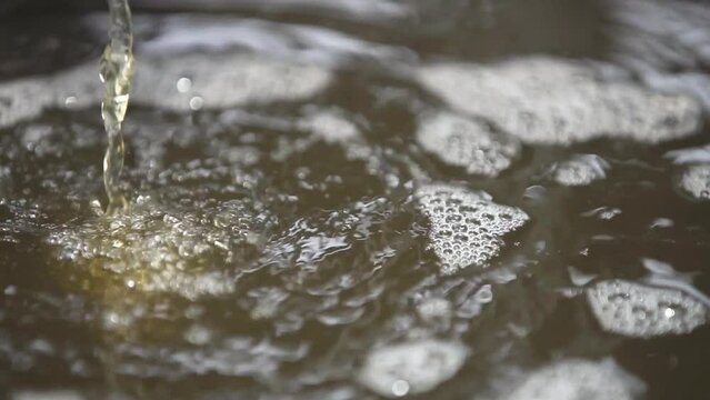 The refined biodiesel is flowing into the oil reservoir.