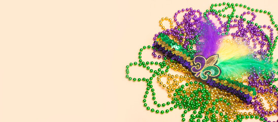 A venetian, mardi gras accessories on beige background. Horizontal festival  poster, greeting cards, headers, website.