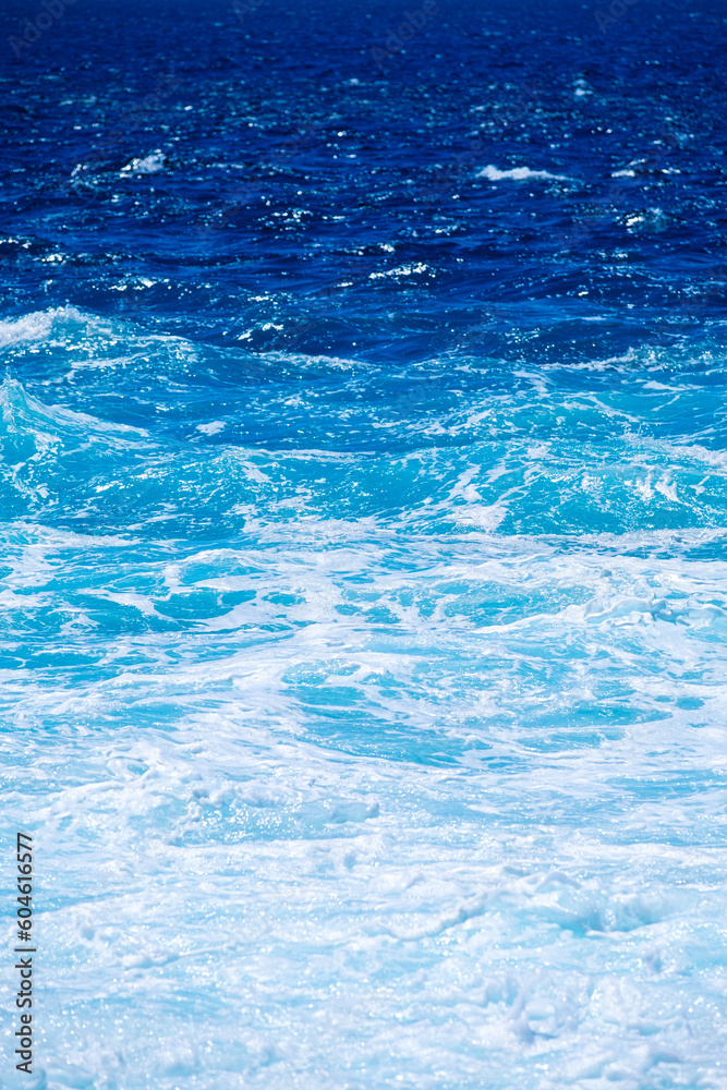 Wall mural the sea as a background. waves and sea foam. water color gradient. nature photo for design and backg