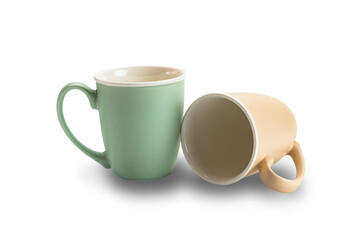 Closeup view of two empty ceramic coffee mugs brown and green isolated on white background with clipping path.