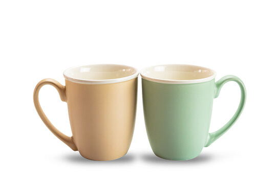 Side View Of Two Empty Ceramic Coffee Mugs Brown And Green Isolated On White Background With Clipping Path.