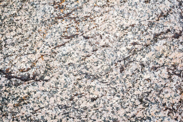 The texture of a stone from chipped granite, a close-up of the surface of the rock.