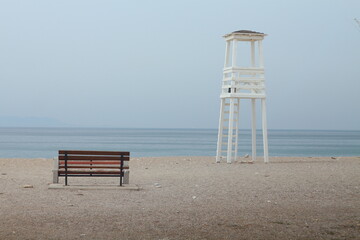 Bench overlooking the sea and lookout tower. without processing